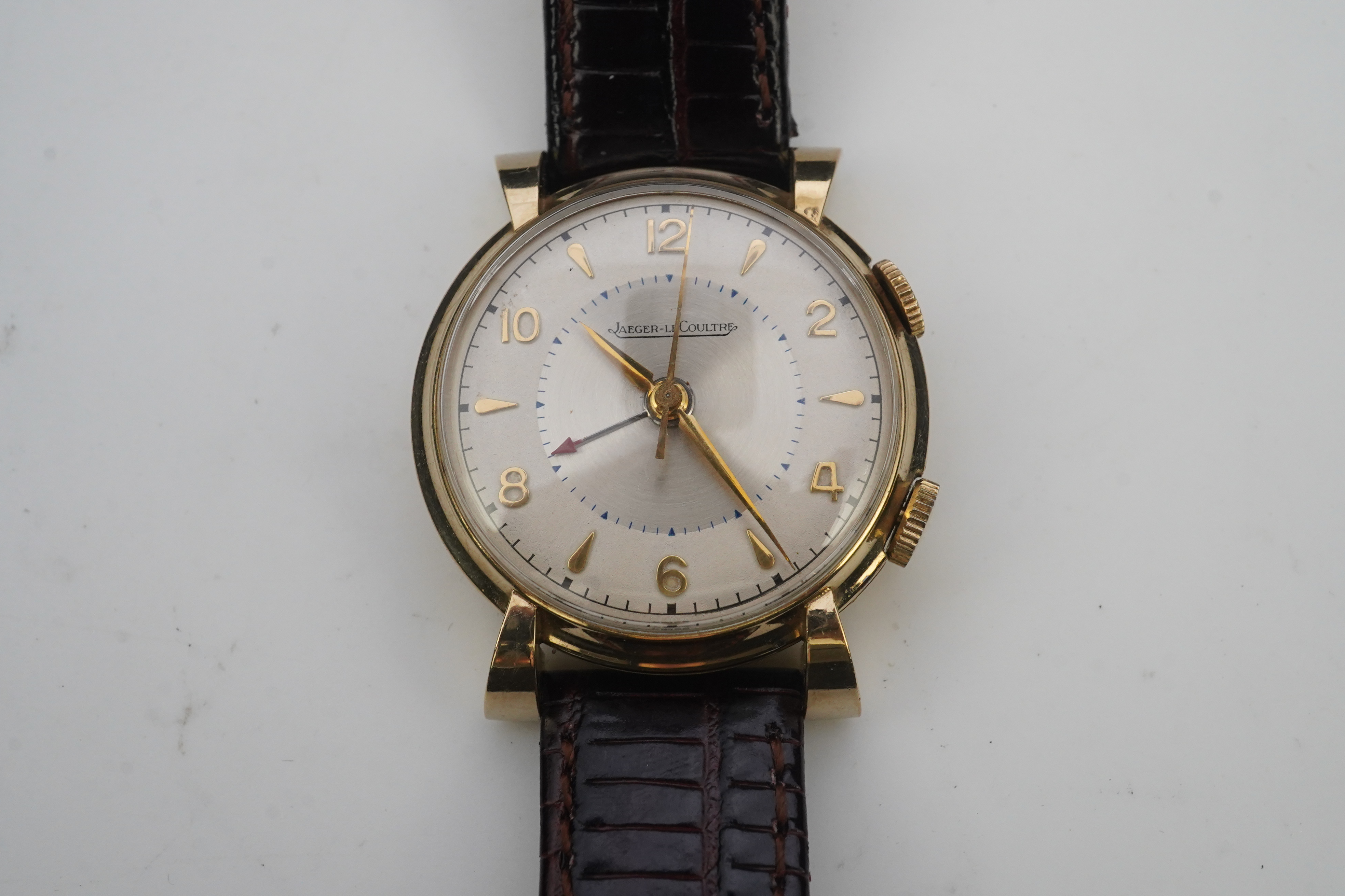 A gentleman's 1950's gold plated Jaeger LeCoultre Memovox manual wind wrist watch, on a later associated leather strap